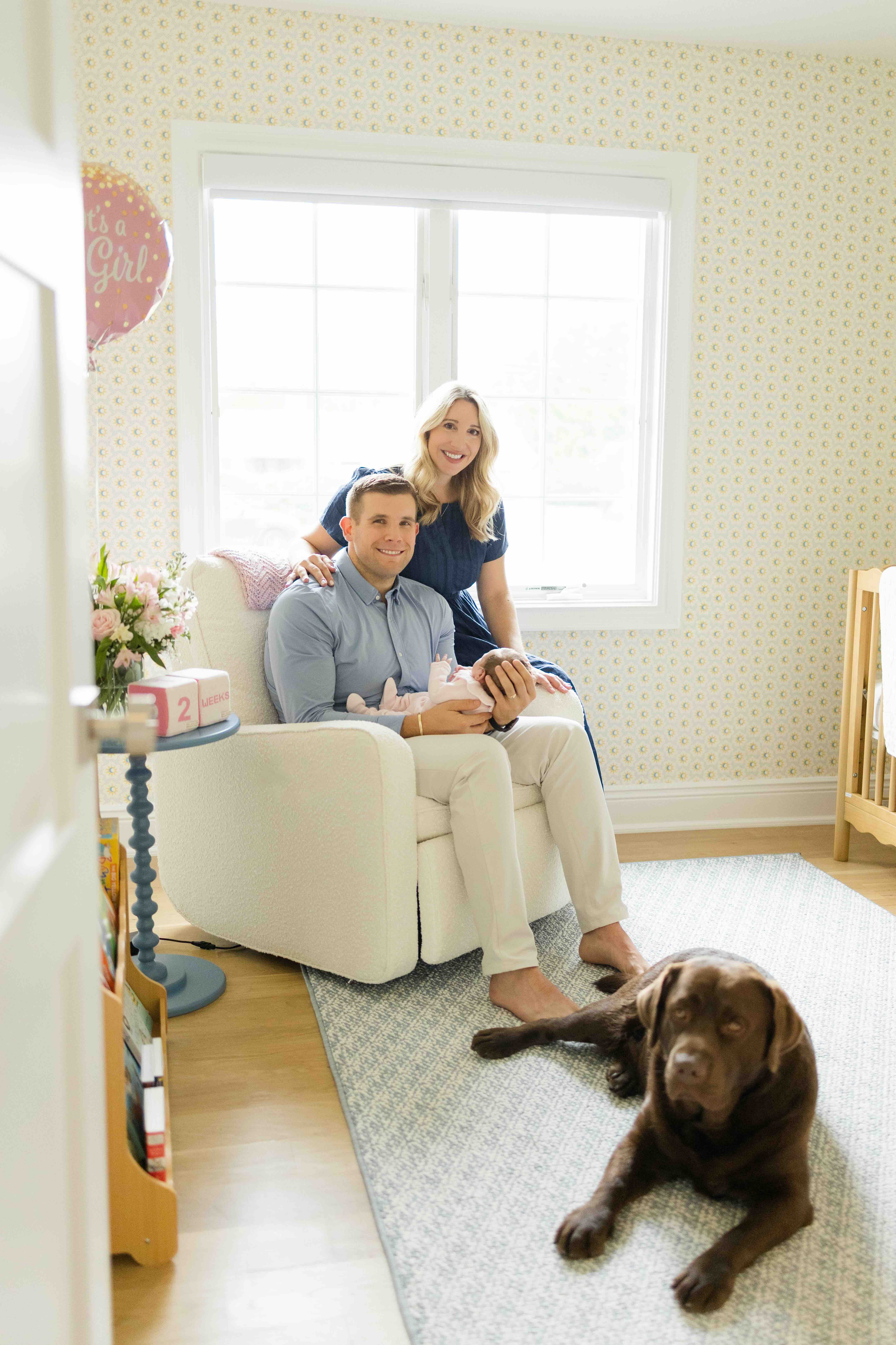 Nicole's family at home with their chocolate lab, Hank